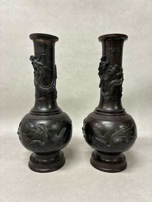 two vases that are sitting on a table