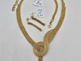 a gold necklace with a knot and a chain