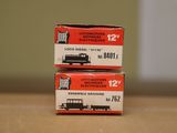 two boxes of electric trains sitting on a table