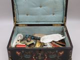 a black and blue suitcase with a lot of things inside of it