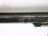 a close up of a gun on a white surface