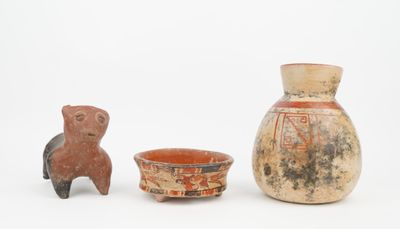 three pieces of pottery sitting next to each other on a white surface