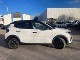 a white suv parked in a parking lot next to a building