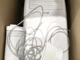 a white air conditioner sitting inside of a cardboard box