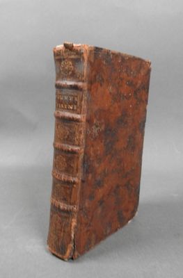 an old book sitting on top of a table next to a gray background