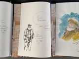 a lot of drawings on the pages of a book