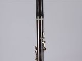 a close up of a clarinet on a clear surface with a white background