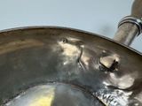 a metal pan with a handle that has a fish on it