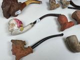 many different types of smoking pipes on the table
