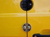a close up of a door handle on a yellow car