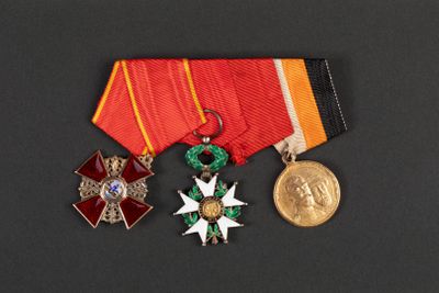 three medals and a medal on a black surface