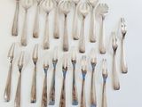 a lot of forks and spoons on the table