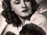 an old black and white photo of a woman in a fur stoler