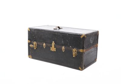 a black trunk with gold handles on a white background