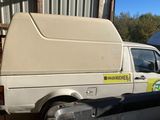 a van that is sitting in the back of a truck