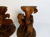 two wooden vases with carvings of animals on them