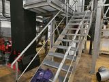 a metal staircase going up to the top of a building