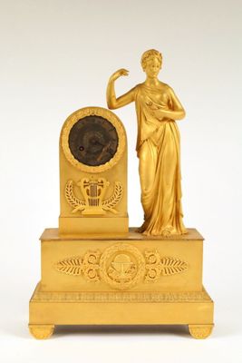 an image of a gold clock with a statue of a woman on top of it