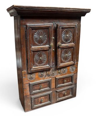 an old wooden cabinet with four drawers and a door