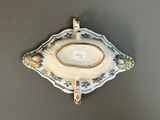 a decorative tray with a clock on it on the wall