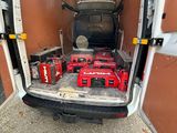 the back of a van with a lot of tools in the back