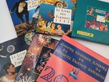 four children ' s books are lined up on a white surface