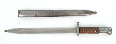 two different types of knives on a white surface