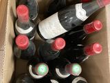 many bottles of wine in a box on the floor