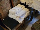 a pile of clothes sitting on a chair in a room