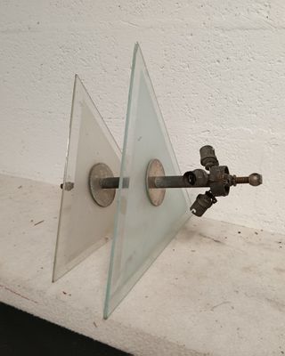 an image of a glass and metal object on a wall
