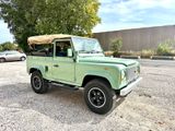 an image of a green land rover parked in a parking lot