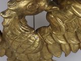 a gold colored clock with an eagle on it