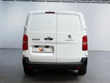 the back of a white van is parked in a garage