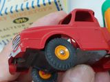 a person holding a red toy truck in front of a crayon crayon crayons