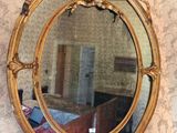 a mirror hanging on a wall in a room