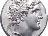 a close up of a silver coin with a man ' s head on it
