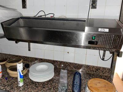 a stainless steel counter top in a kitchen with dishes on it