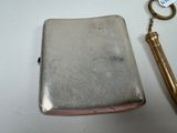 a silver case with a key on it and a keychain