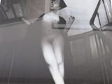 a black and white photo of a woman standing on a rug