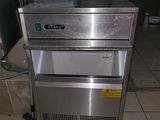 a stainless steel freezer sitting on the floor in a kitchen