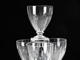 three wine glasses sitting on top of each other on a table