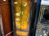 a cabinet that has a clock on top of it