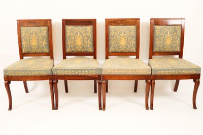 four chairs with upholstered back and upholstered seat covers