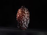 dried dates in a glass jar on a black background