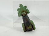 statue of a man riding a motorcycle with a tree on the back of it