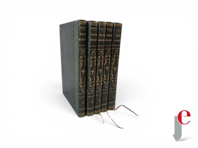three books are stacked on top of each other on a white surface