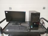 a desk with a computer, keyboard, and mouse on it