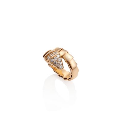 a gold ring with diamonds on a white background