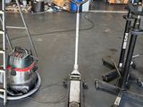 two vacuums that are on the floor in the garage