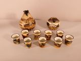 a group of cups and a vase on a table